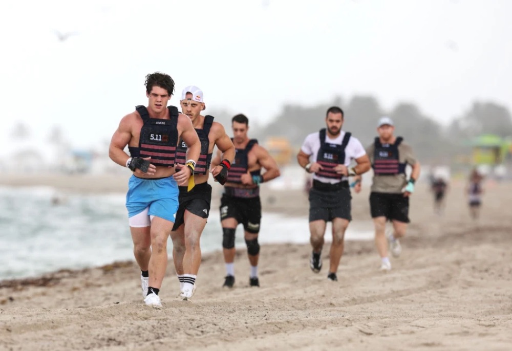 Athletes running on the beach during a Wodapalooza workout